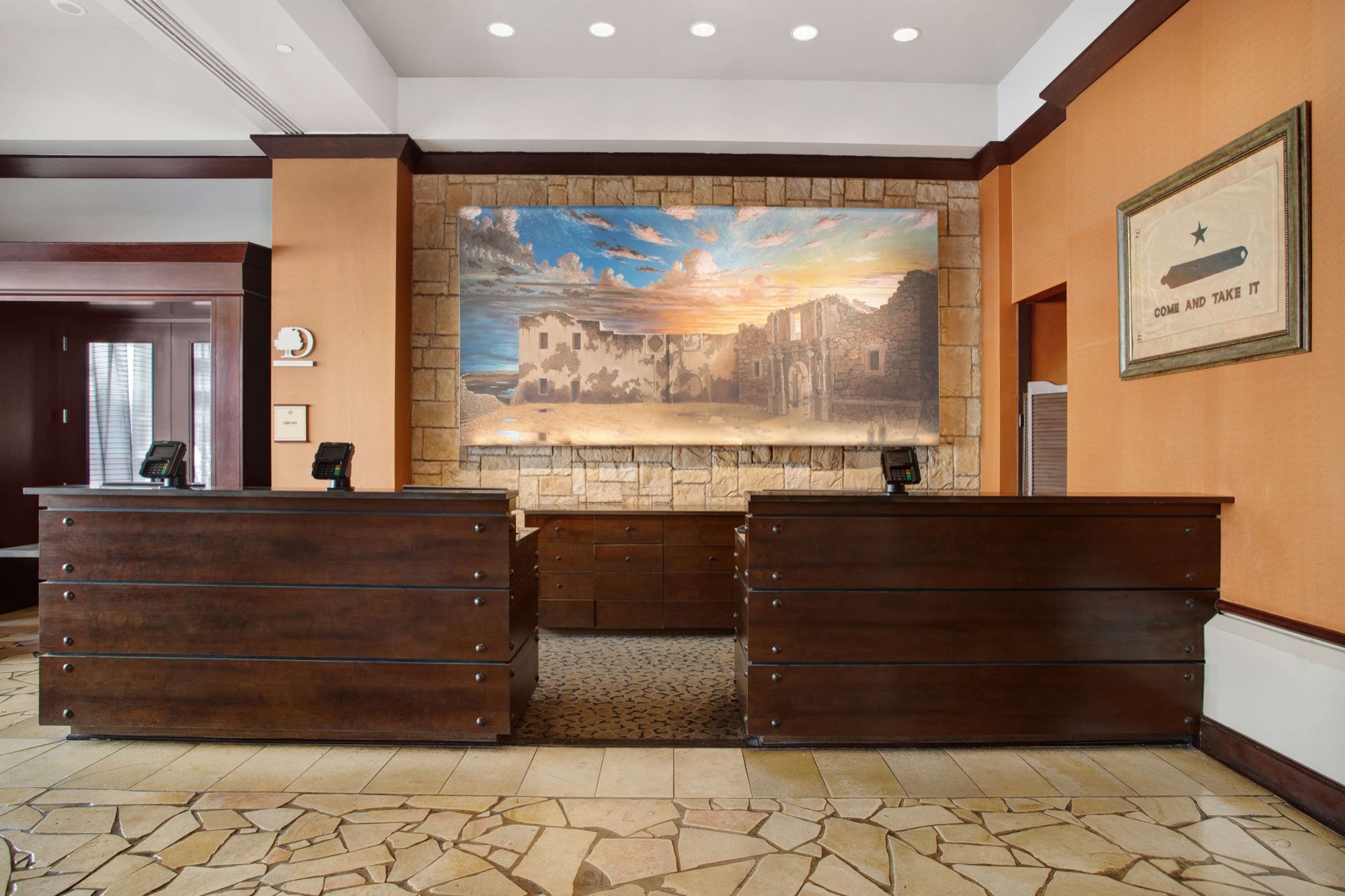 Front desk with San Antonio mural